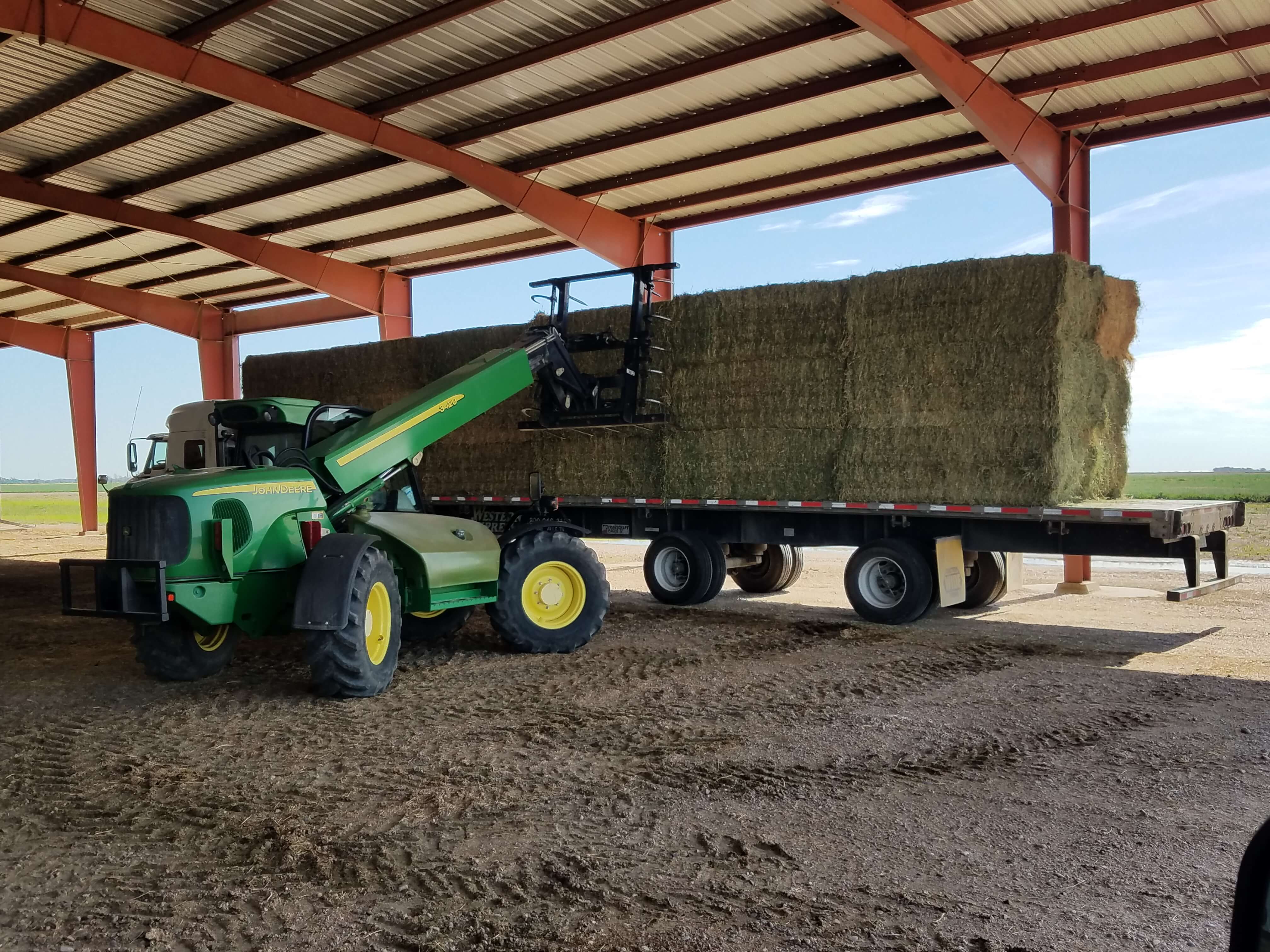 tractor lifting Hay